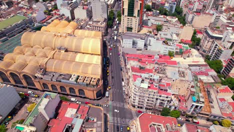 aerial orbit establishing the abasto shopping and almagro neighborhood on a sunny day, special architecture of buenos aires, argentina