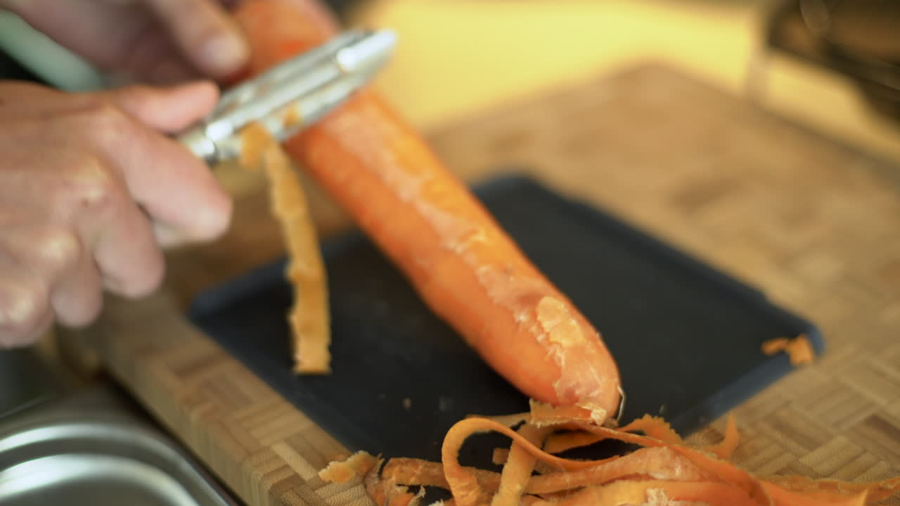Close Up of Female Hands Peeling Carrot 