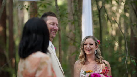 smiling bride and groom laugh during outdoor wedding ceremony, 4k resolution slow motion