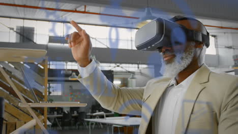 blue digital icons floating against african american senior businessman wearing vr headset at office