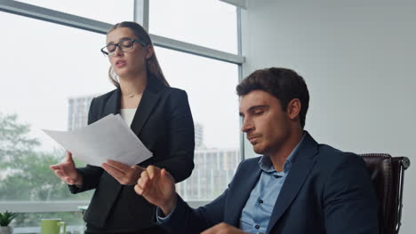 confused manager talking boss explaining mistakes. angry man throwing papers