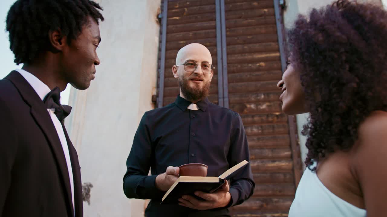 Interracial Wedding Ceremony with Priest