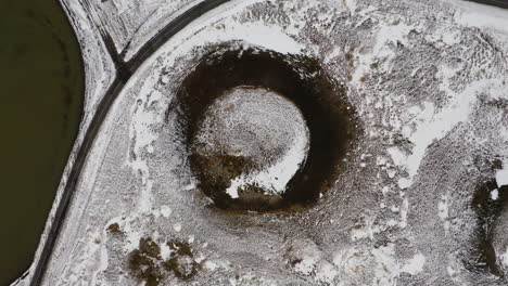 Aerial:-Top-down-shot-of-pseudocrater-near-lake-Myvatn-during-winter