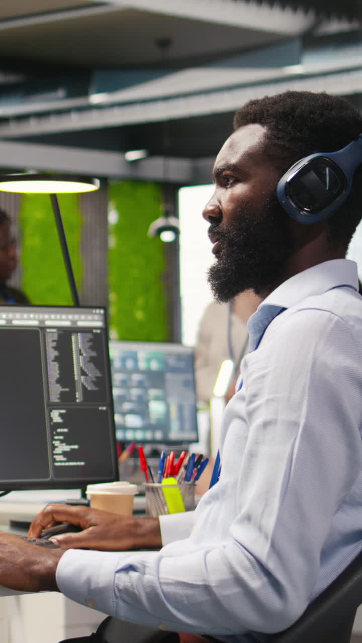 Vertical video Engineer coding with AI language model assistance in office, listening music