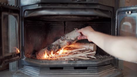 Arranging-The-Firewood-Inside-The-Log-Burner