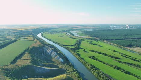 river landscape with power plant and farmland