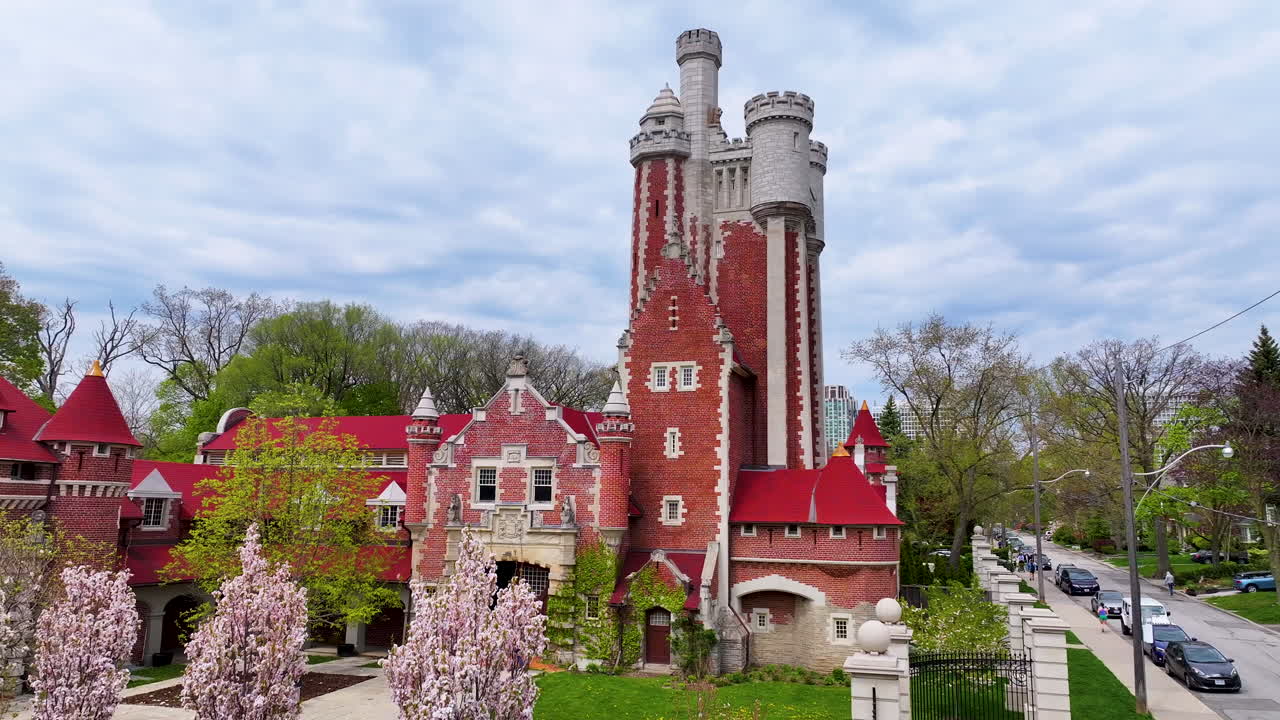 Drone landing in front of gothic buildings by Casa Loma in Toronto