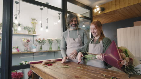 flower shop workers arranging elegant bouquet