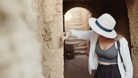 woman restoring ancient wall