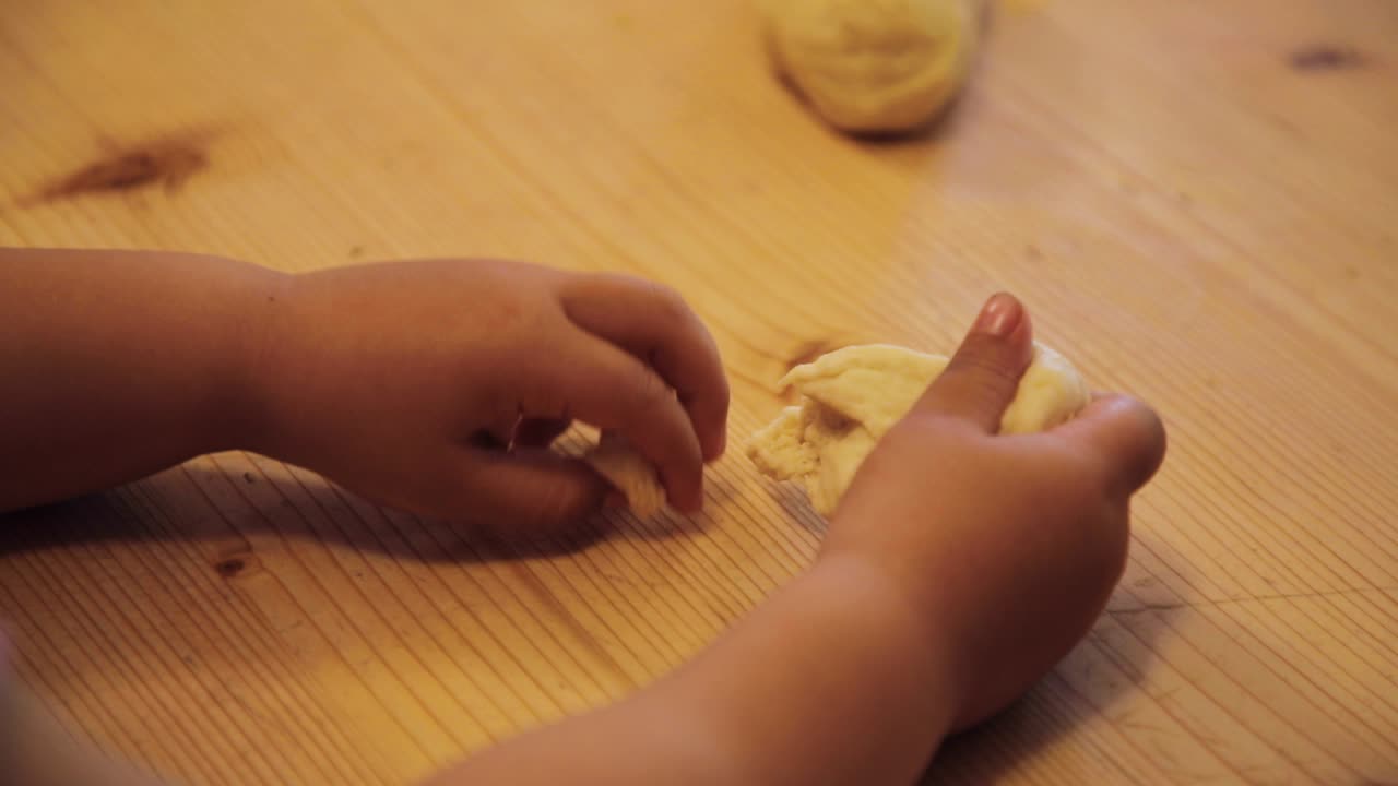 A child girl playing with dough