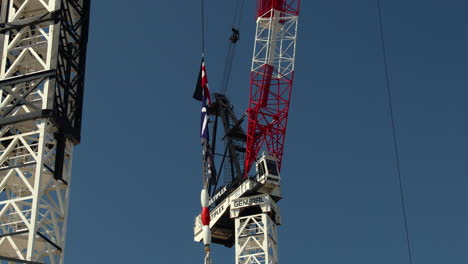 an australian flag flies on a construction site, symbolizing progress, development, and national pride. this footage is perfect for projects related to construction, infrastructure, urban growth.