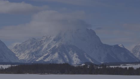 Handheld-shot-of-a-high-mountain-with-clouds-around-the-summit