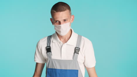 young man putting glasses and face mask off