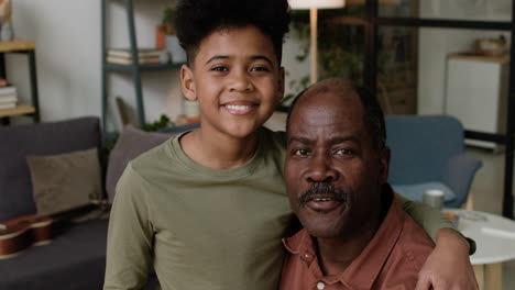 Grandfather-and-grandson-hugging-at-home