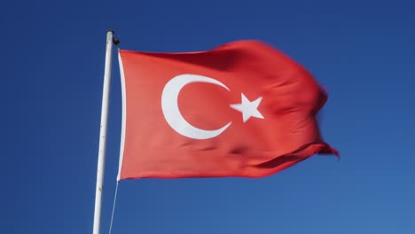 turkey flag waving in wind. national flag of turkey. turkish flag flattering on background of blue sky