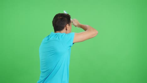 rear view of a man waving a argentine pennant