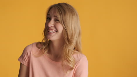 caucasian woman winking on camera.