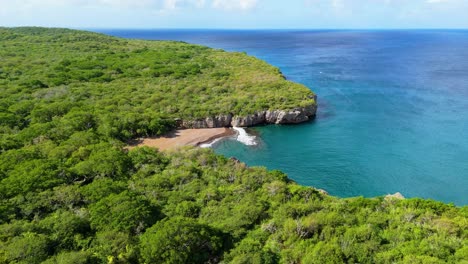 aerial establish of playa santu pretu black sand beach cove and shallow reef ledge