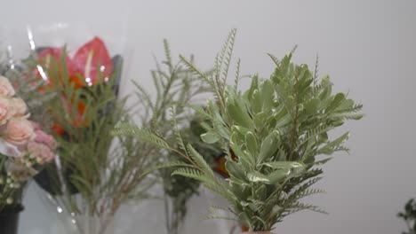 florist shaking greenery to be used in a valentine's day arrangement