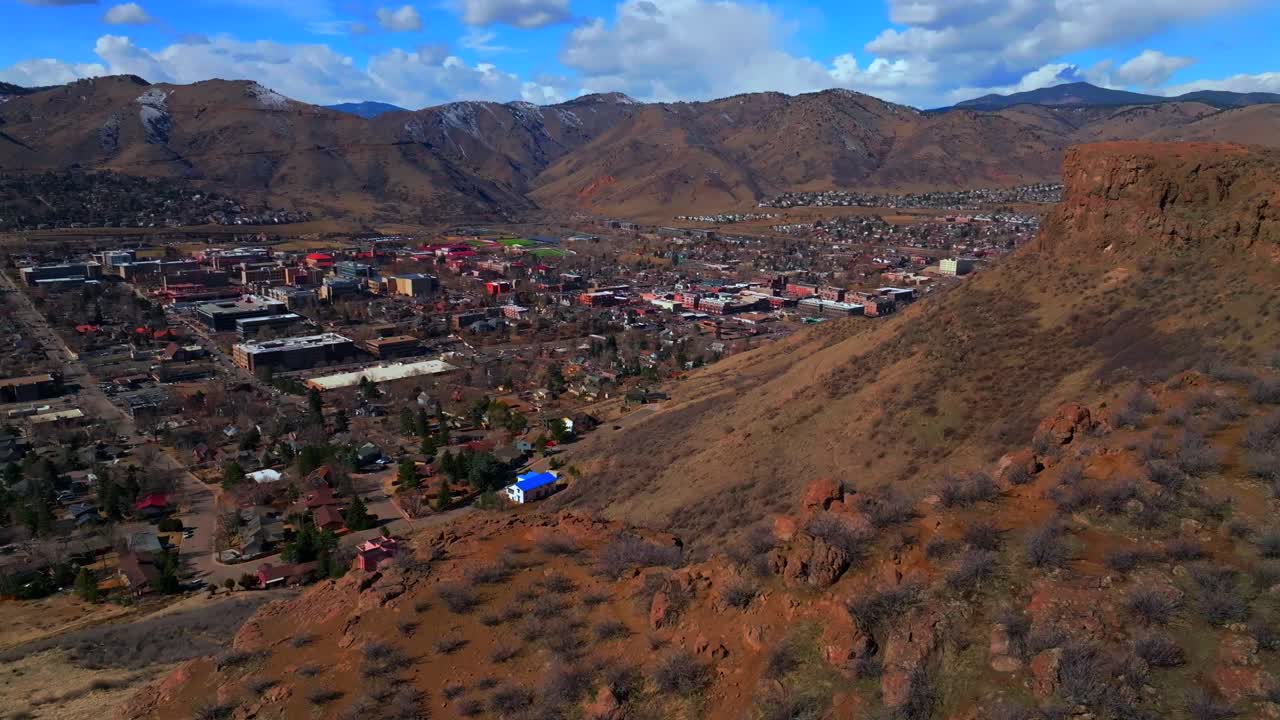 North Table Mountain Historic downtown Golden Colorado aerial drone Golden Gate Canyon winter sunny morning afternoon blue sky nieghborhood homes Clear Creek River Coors Beer Factory circle right