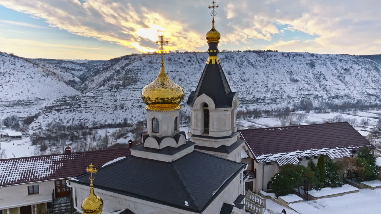 Aerial drone view of the Old Orhei covered in snow at sunrise. Monastery located on a hill in Moldova