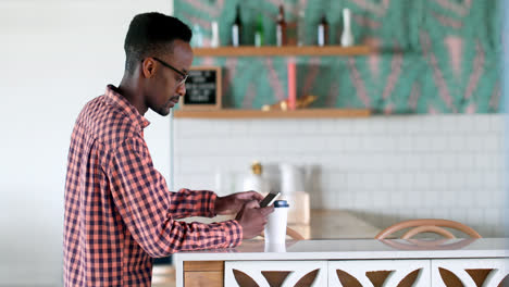 Male-executive-having-coffee-while-using-mobile-phone-4k