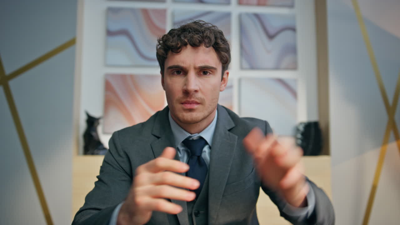 Nervous businessman video calling remotely at office pov. Man throwing papers