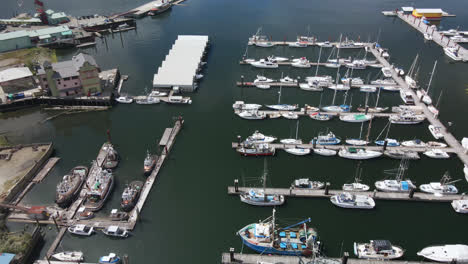Fishing-and-Pleasure-Boats-Docked-at-Port-Alberni-Marina-Docks-in-Vancouver-Island-British-Columbia-Canada,-Aerial-View