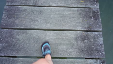 Woman-walks-down-an-old-dock