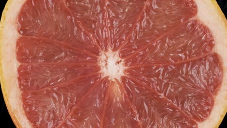 rotation, closeup of fresh, juicy pulp of an grapefruit. background and texture of grapefruit. top view