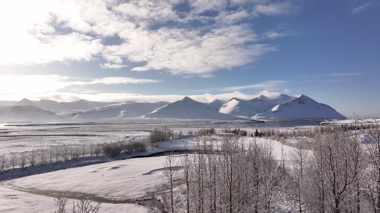 Snow-covered mountains and trees with a scenic winter landscape in Borgarfjörður