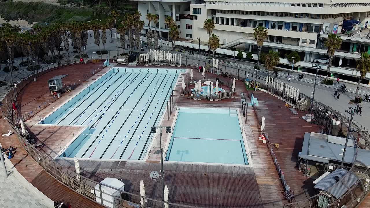 Aerial view of outdoor swimming pool with lanes for competitive swimming and a leisure pool
