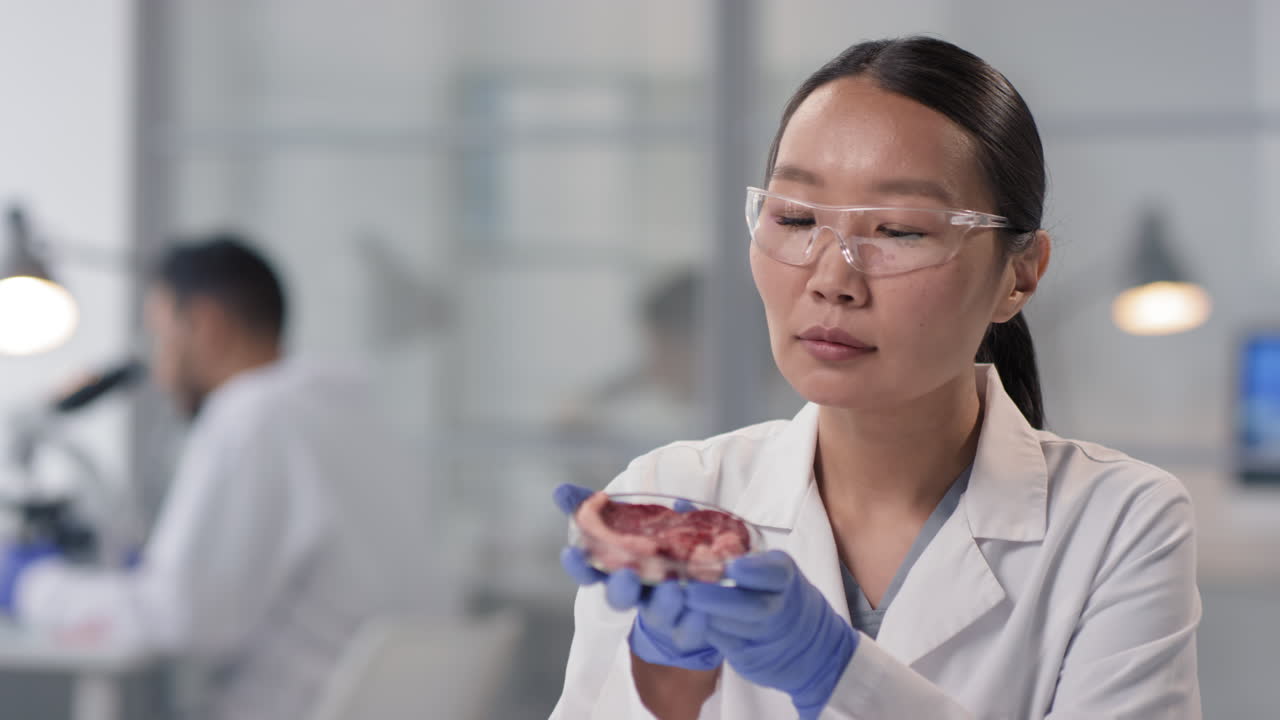 Scientist Examining Meat Sample in Lab
