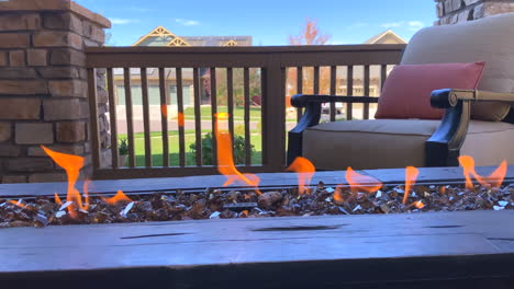 video of a fire pit with flames and a chair on a front porch