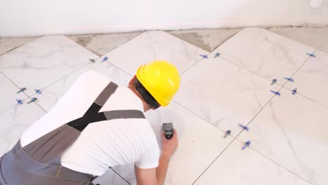 a professional builder installs ceramic tiles in a new building