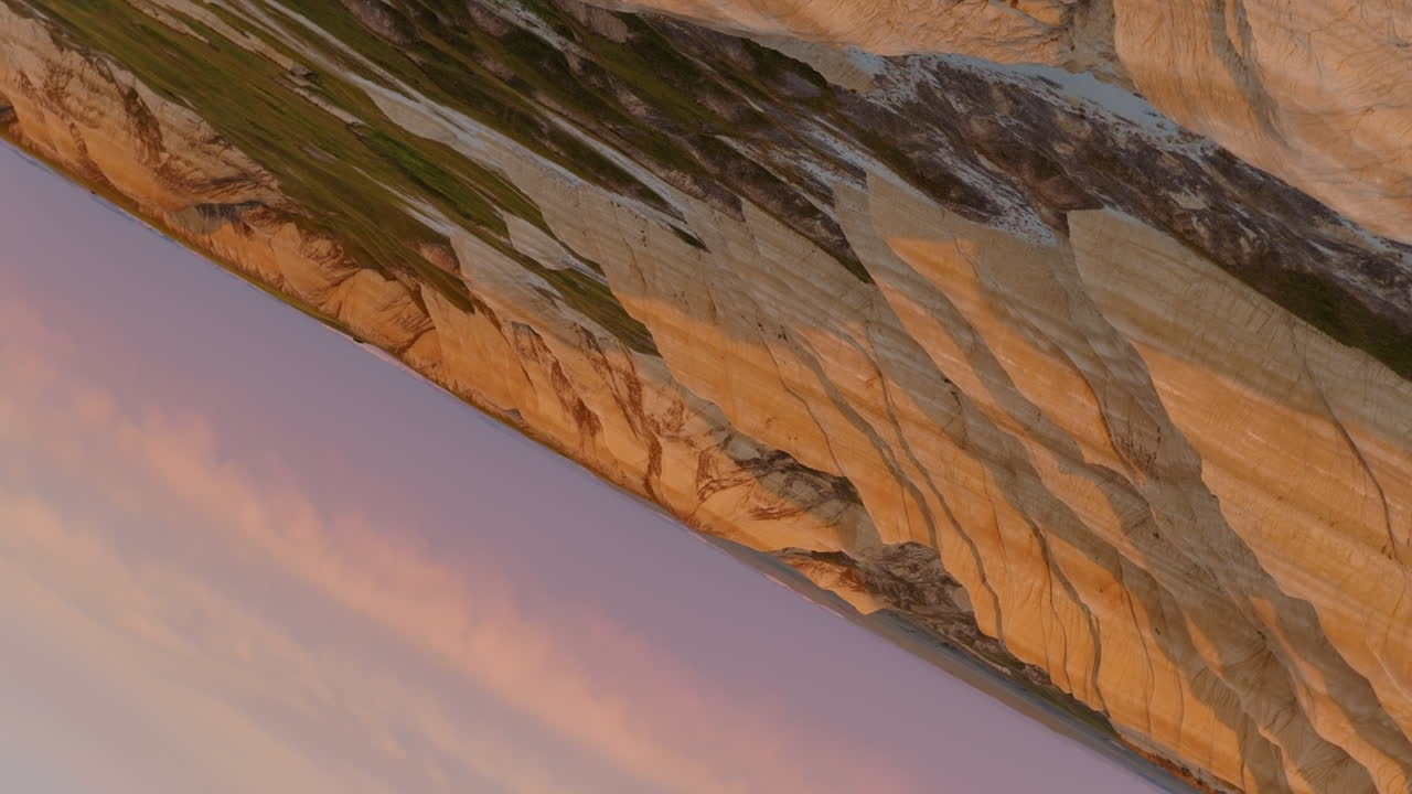 Sunset Radiance Across Harsh Badlands Formations in Drone Views