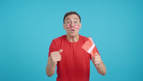 Man cheering for Denmark screaming and waving a national flag