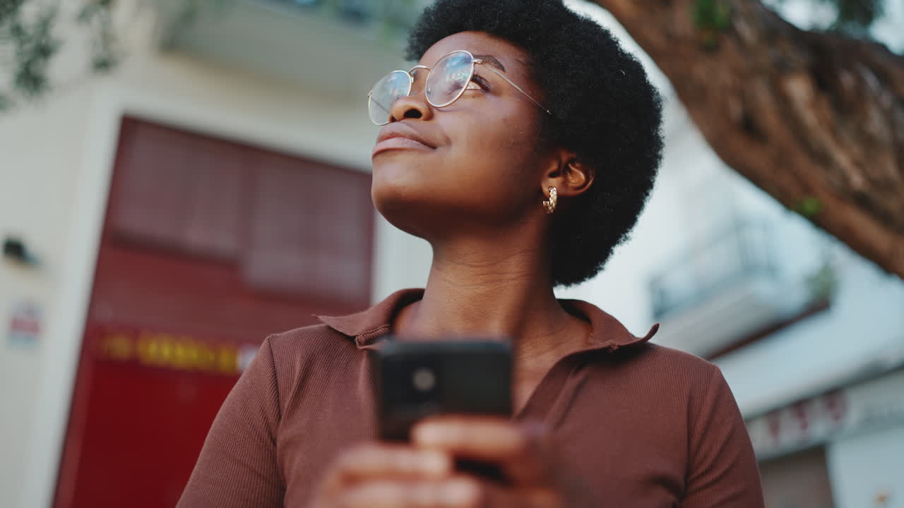 Young dark-skinned woman resting on the street