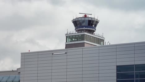 air traffic control tower on airport with rotating radar