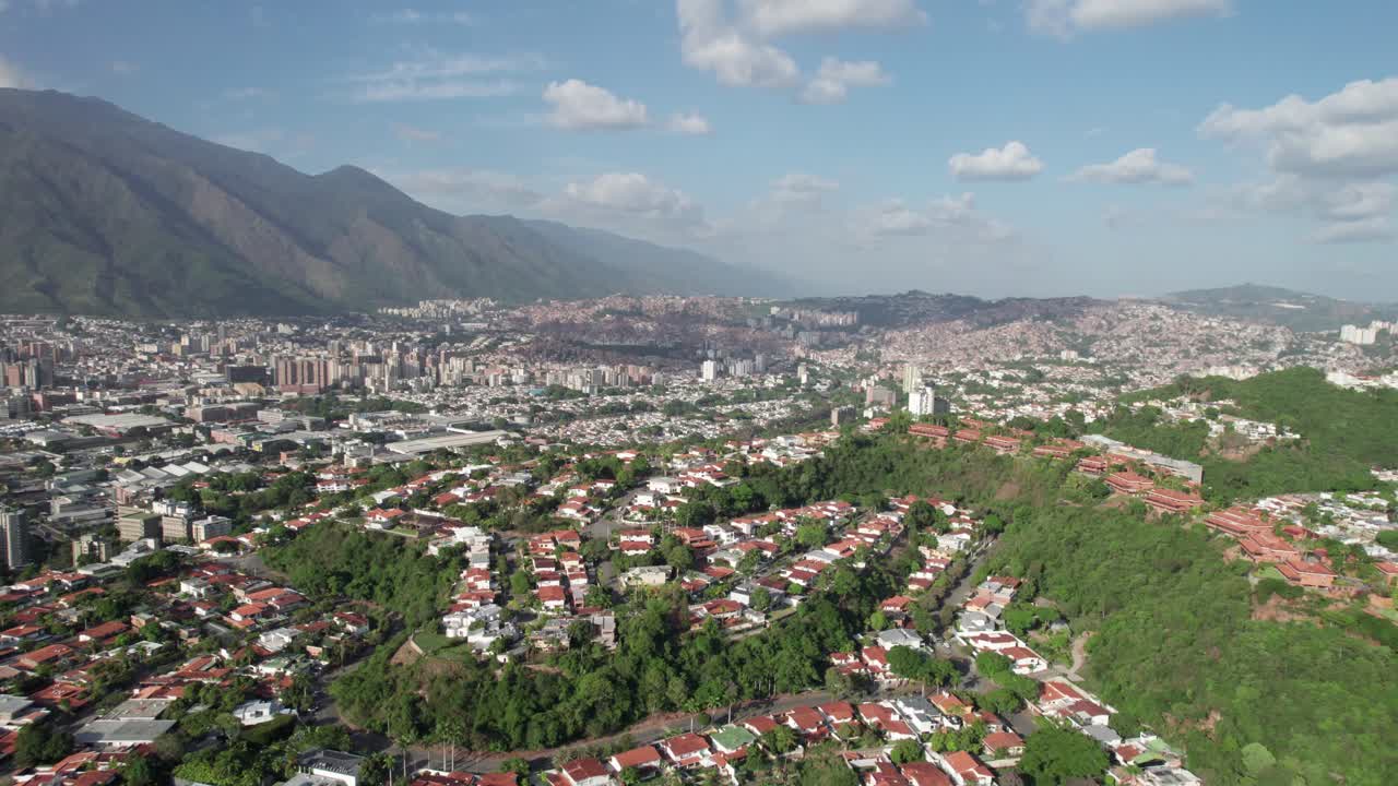 Aerial Views of a Cityscape with Mountains and Urban Development