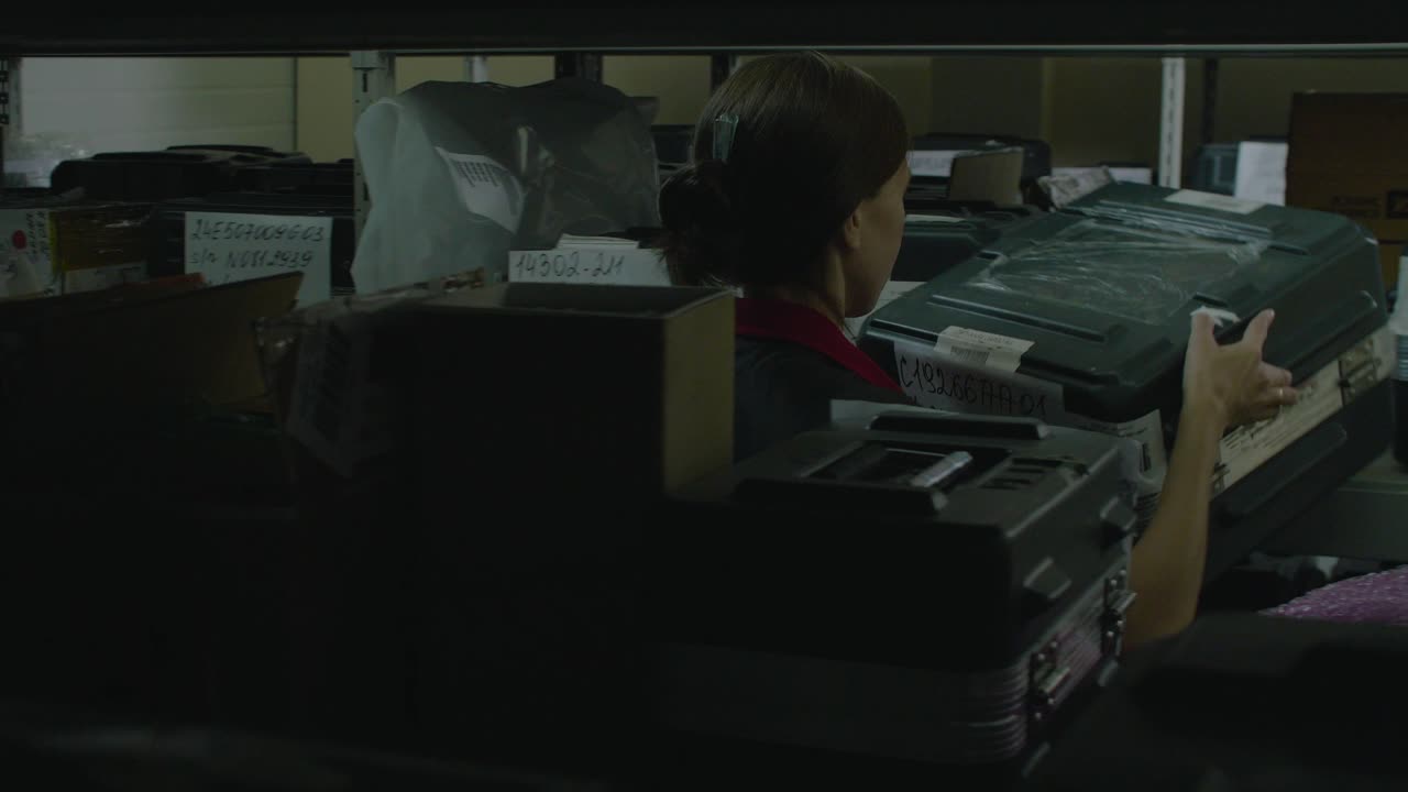 Warehouse Worker Handling Packages on Shelves