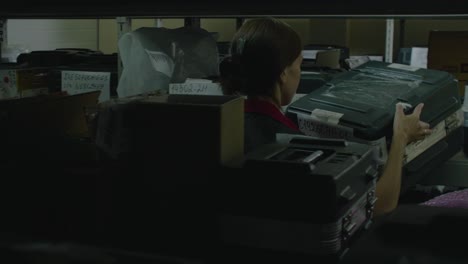 warehouse worker handling packages on shelves