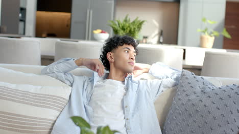 relaxing on couch, teenage boy stretching and enjoying peaceful moment at home