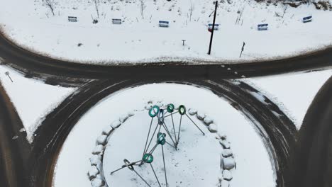 A-metal-and-glass-statue-gleaming-amidst-snow-cover