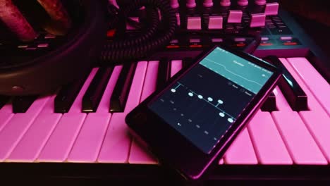 dolly shot of digital audio player with professional headphone on a midi controller