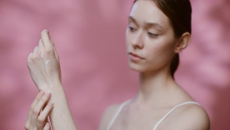 woman applying skincare product to hands