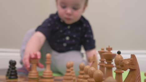 inquisitive baby boy playing a game of chess