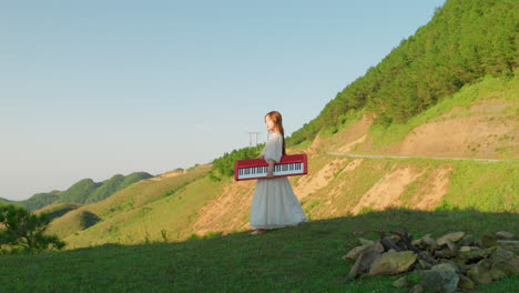 woman carrying a red keyboard on a mountain