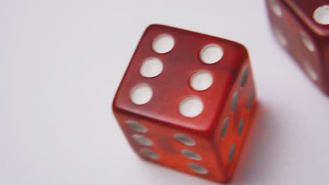 motion past red plastic dices with spots on white surface