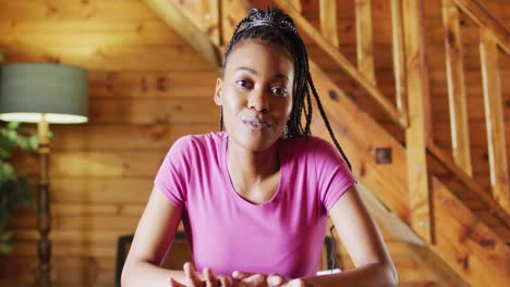happy african american woman sitting at table and having video call, slow motion